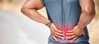 Back pain treatment for Molina patients Physician evaluating a patient with lower back pain at 14 Street Medical Arts, a practice accepting Molina Healthcare in New York City